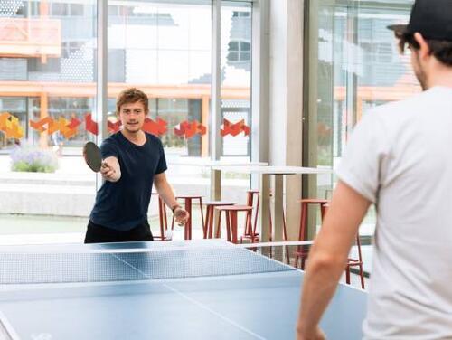 Two people playing indoor table tennis at Plexal