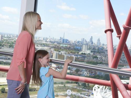 Mum and daughter looking out at London