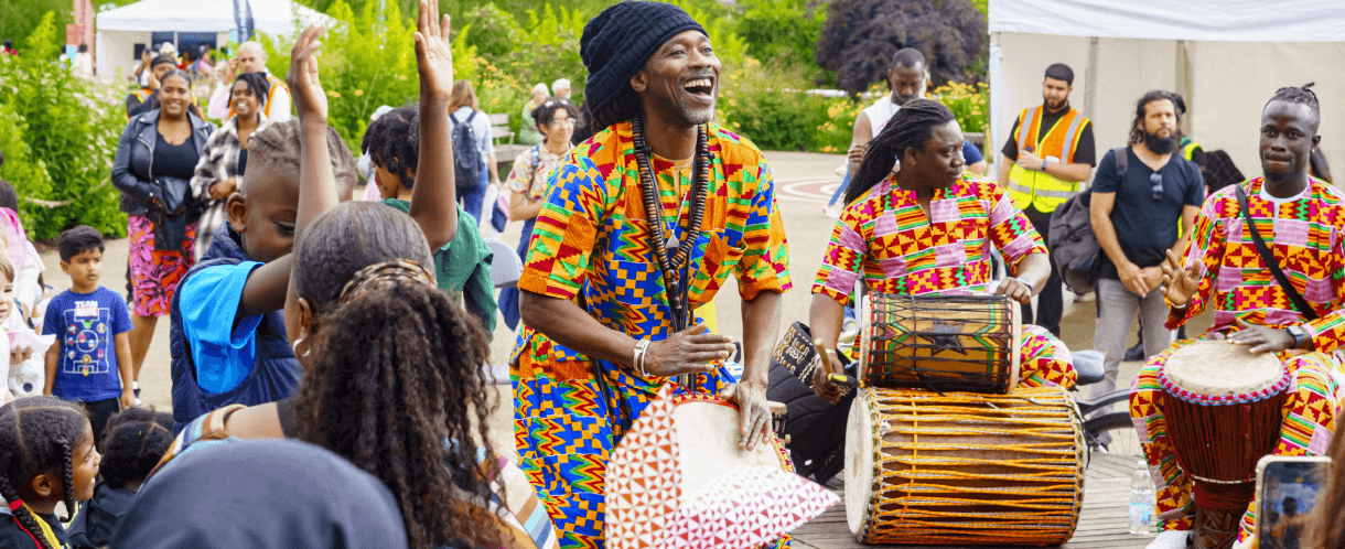 A group of drummers plays for a crowd at the Great Get Together