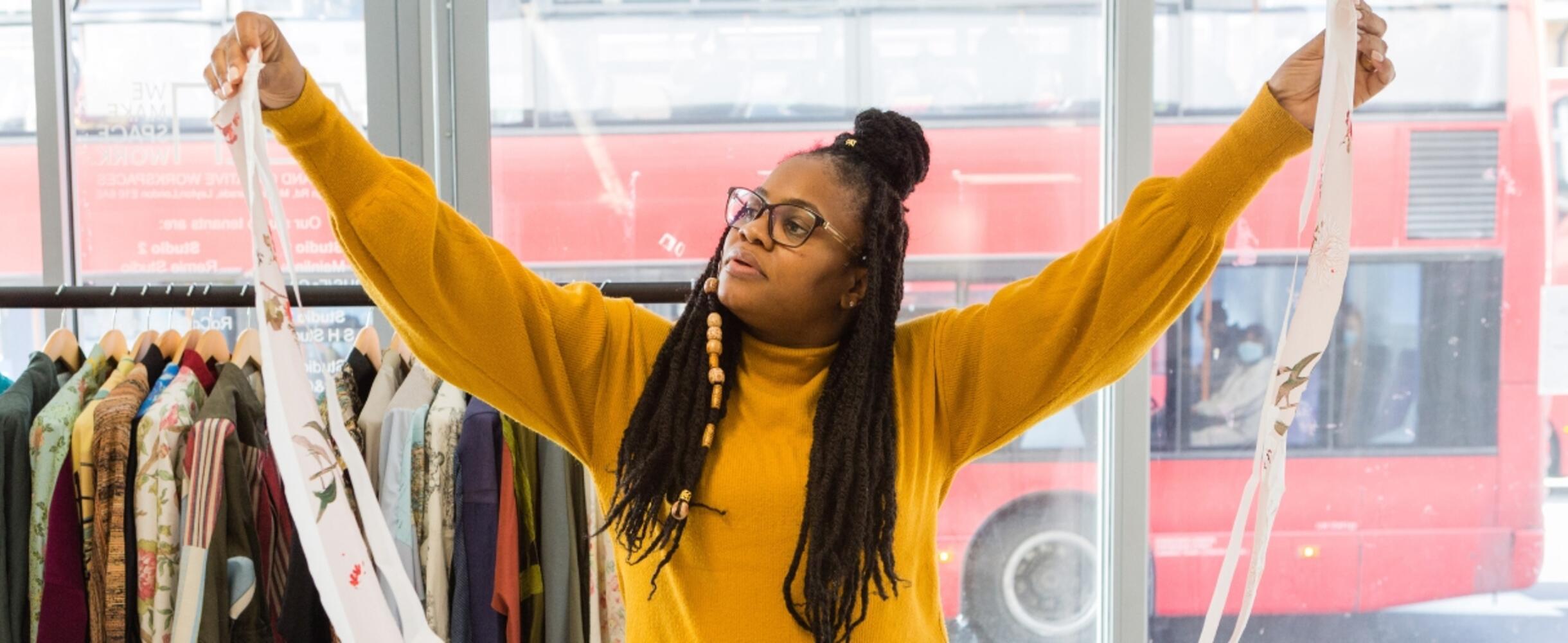 A person holds up a length of fabric