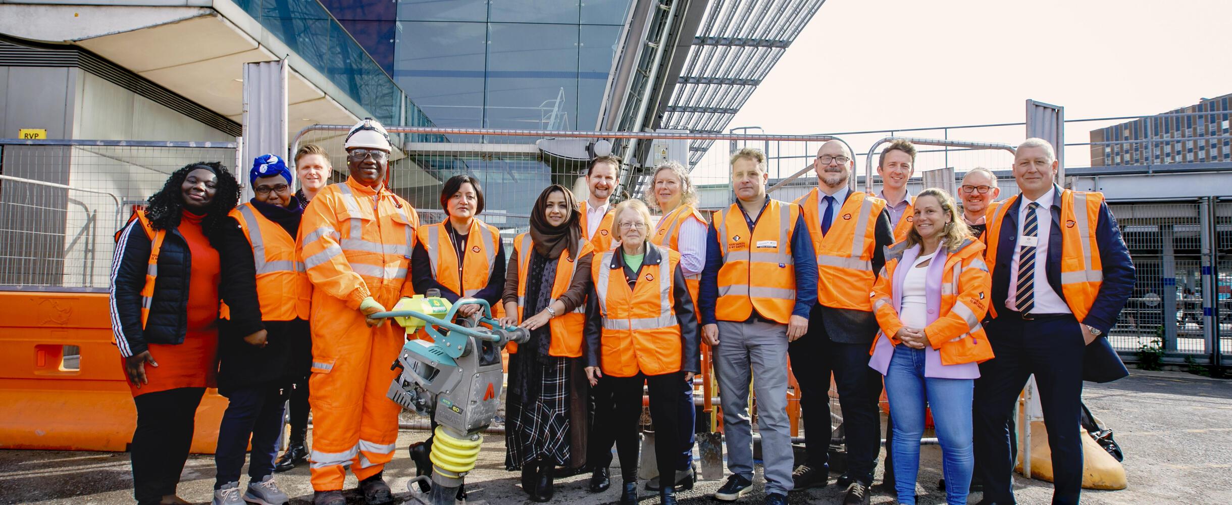 Group of people standing near carpenters entrance Stratford station