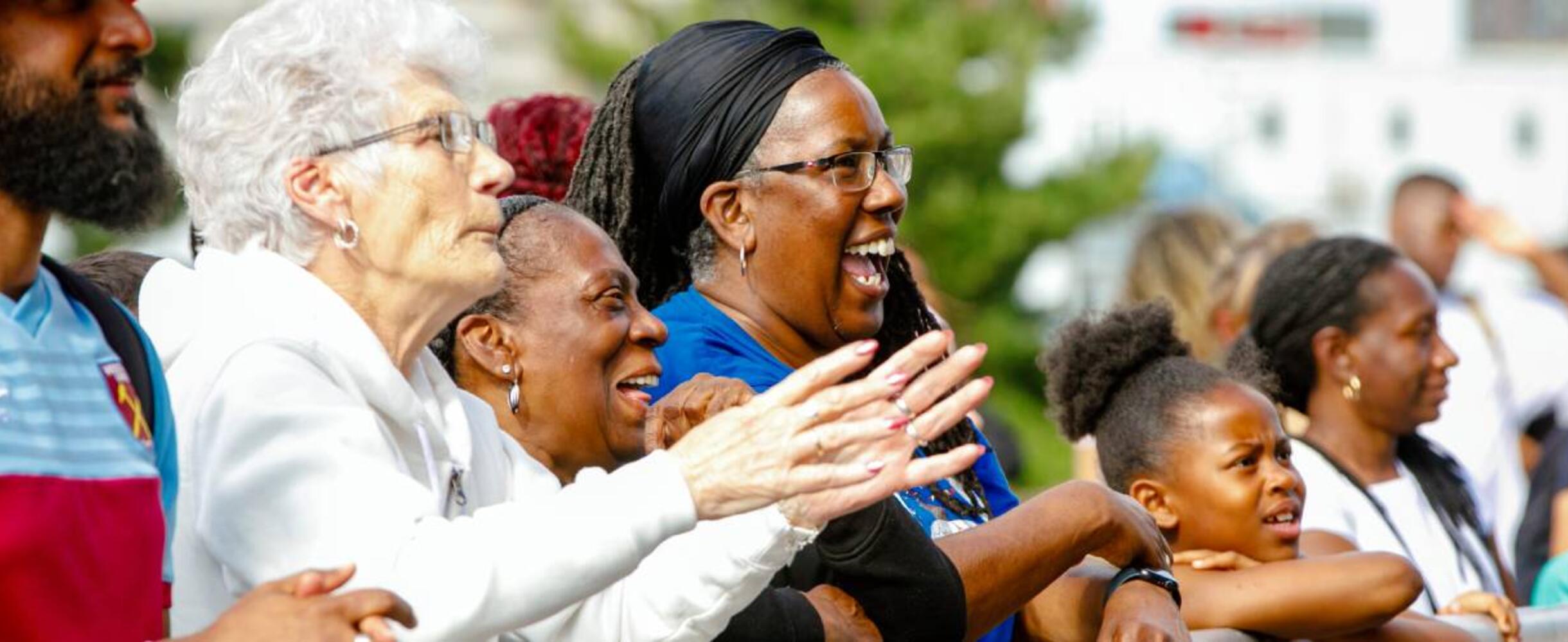 A crowd cheering at Great Get Together on Queen Elizabeth Olympic Park