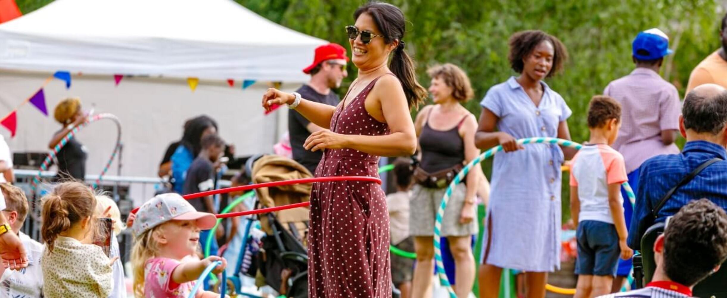 Woman enjoying hula hoops at The Great Get Together