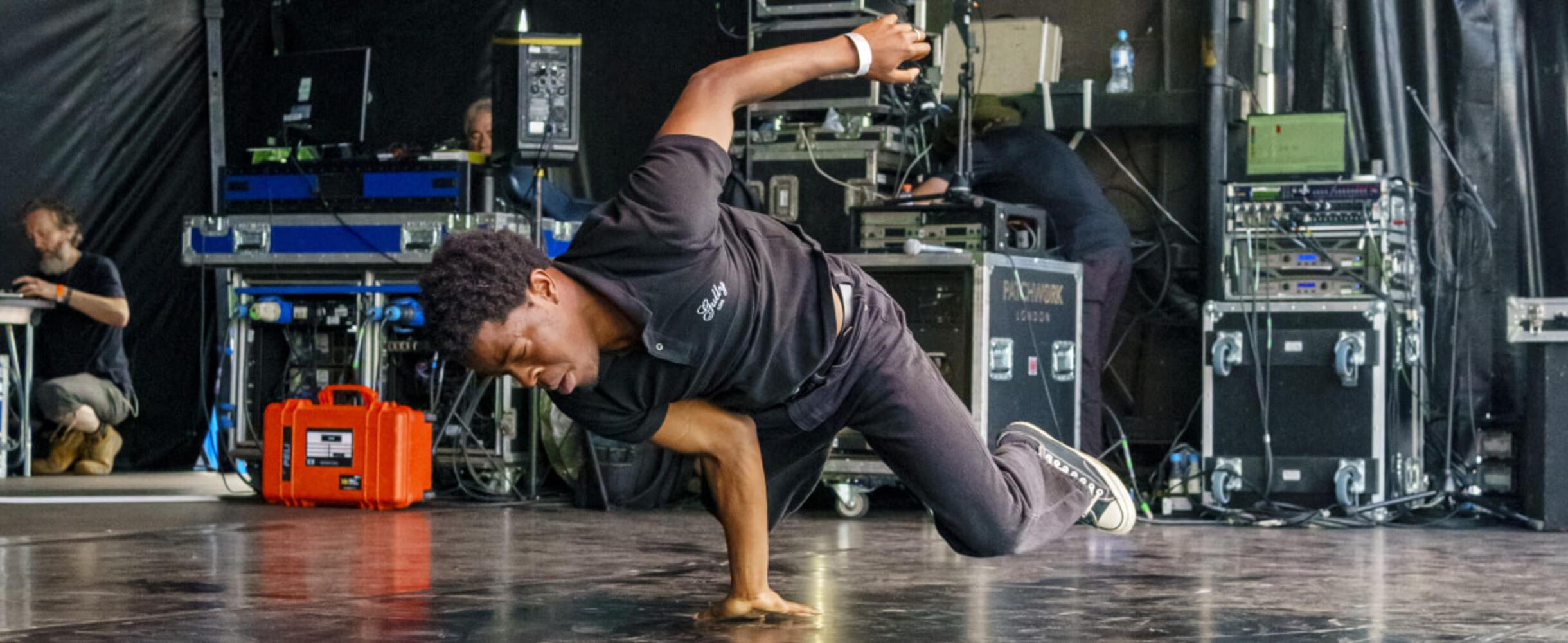 A hip hop dances performs on a stage