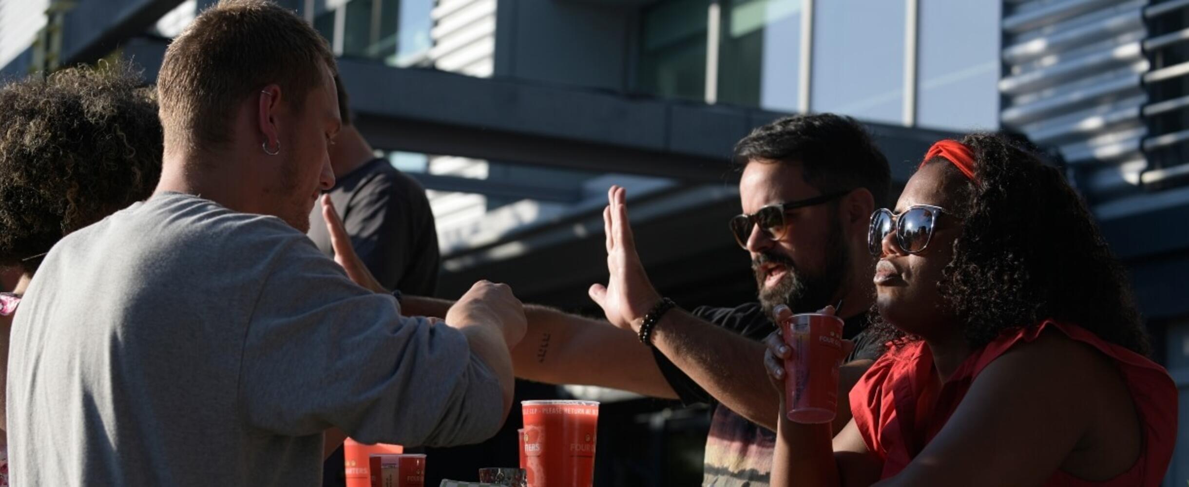 Group of people having drinks at Here East Canalside