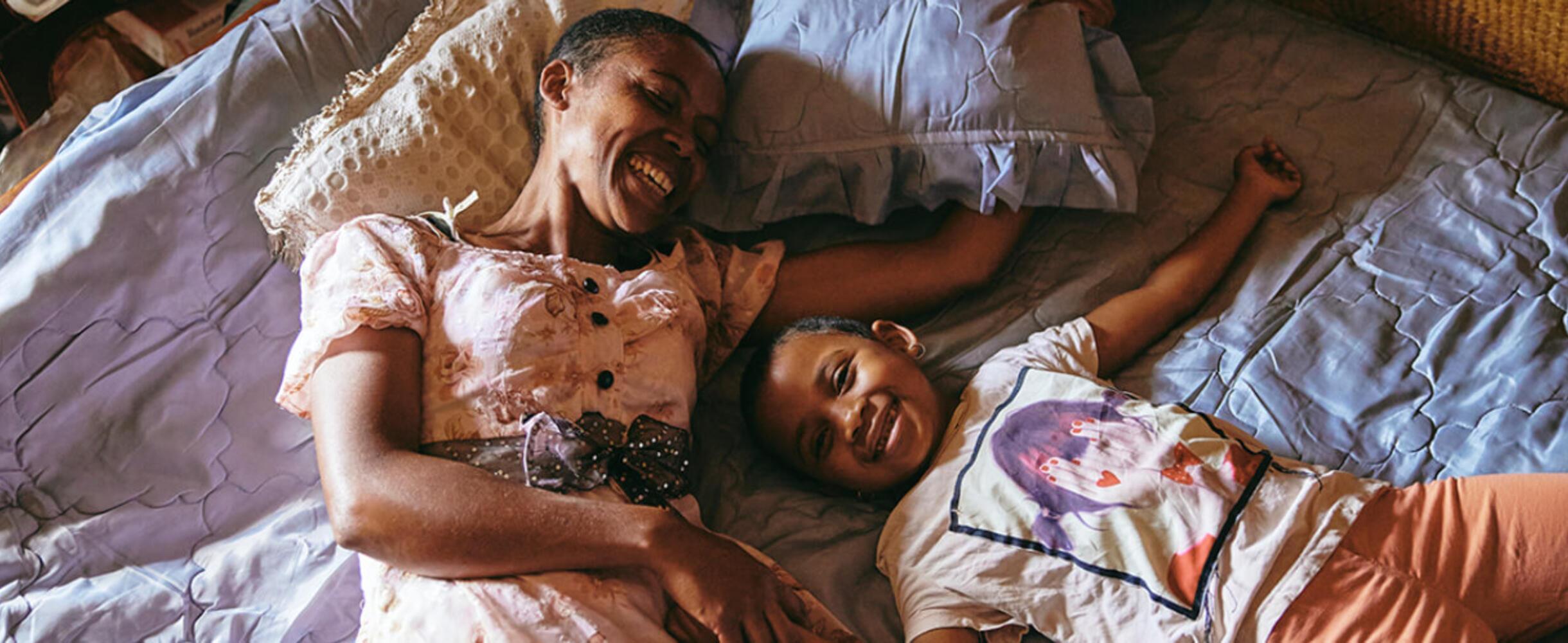 Two people lie down laughing