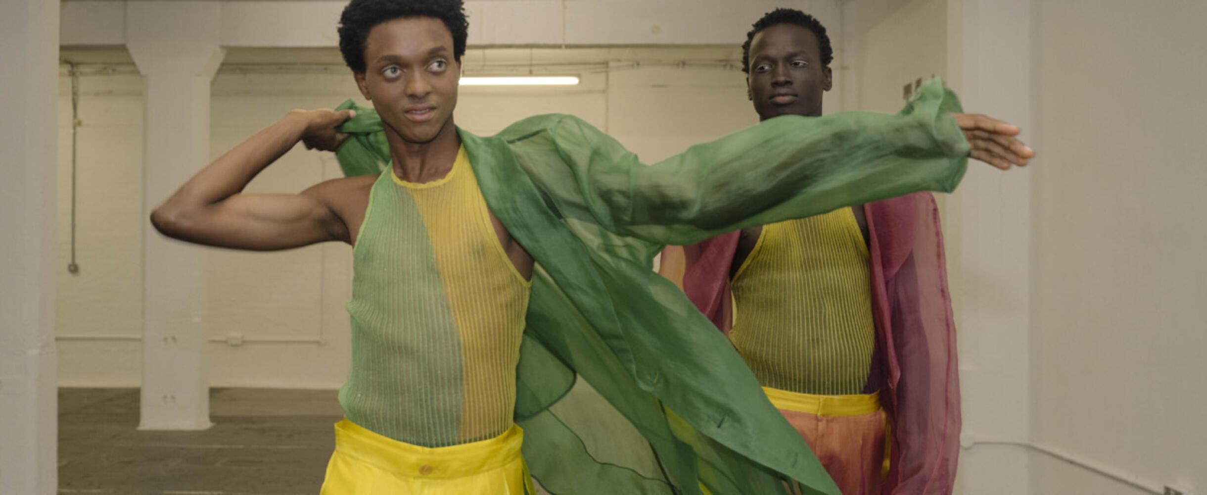 Two models in bright clothes at LCF Postgrad showcase