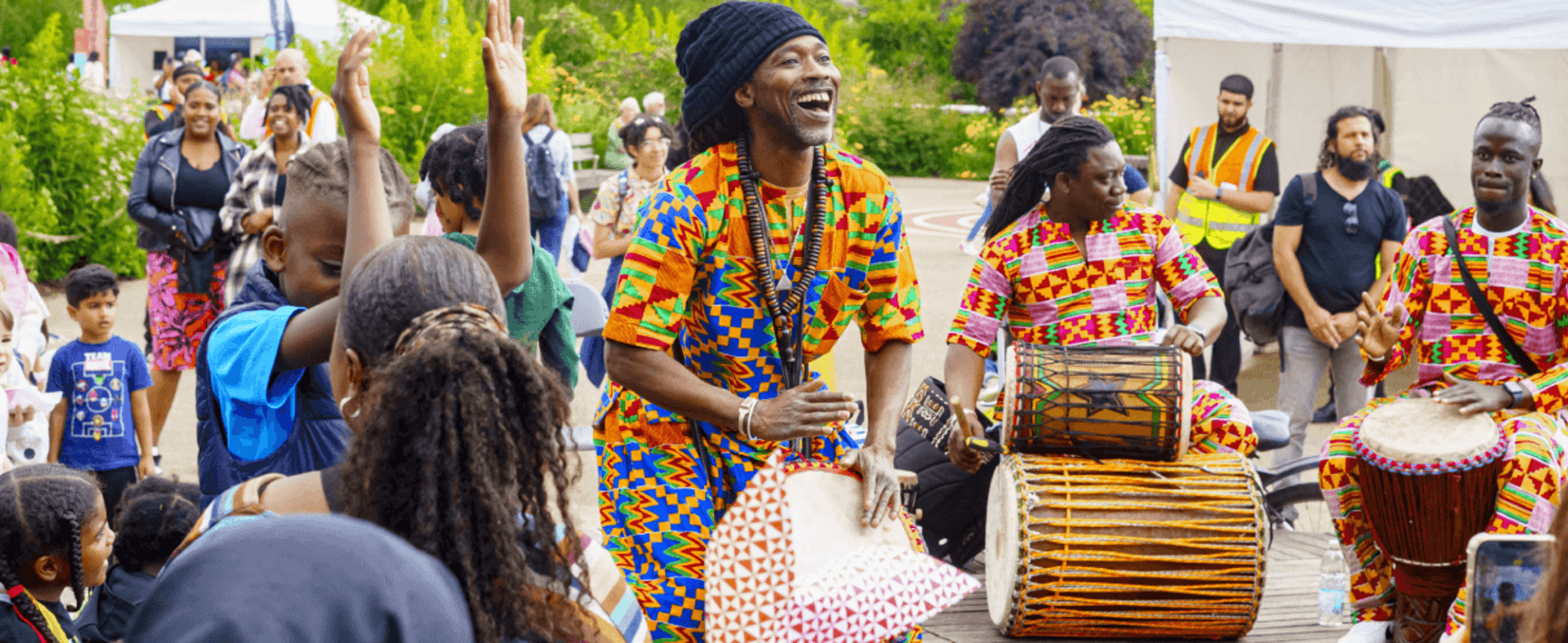 A group of drummers plays for a crowd at the Great Get Together
