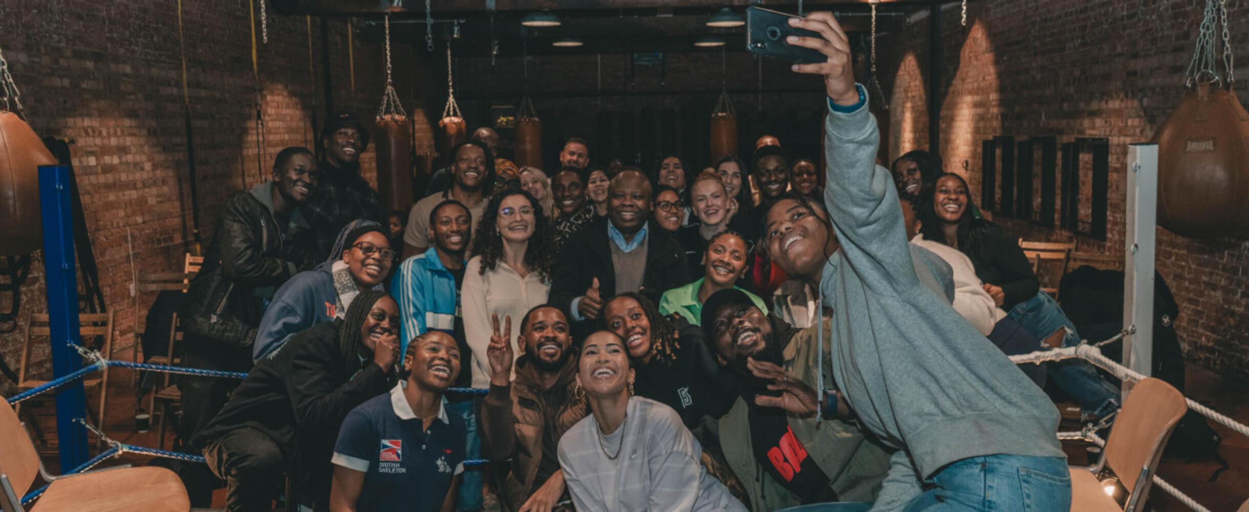 A group of people pose for a selfie