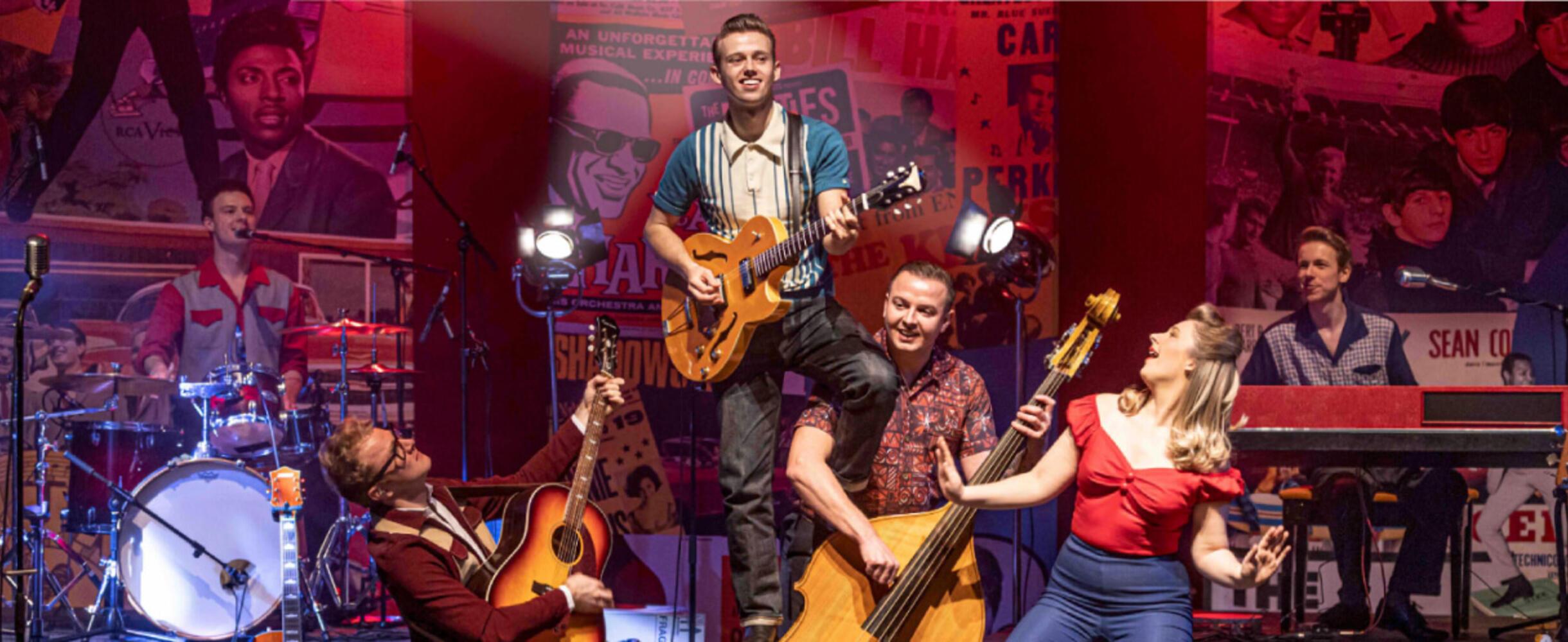 A rock and roll band play on stage