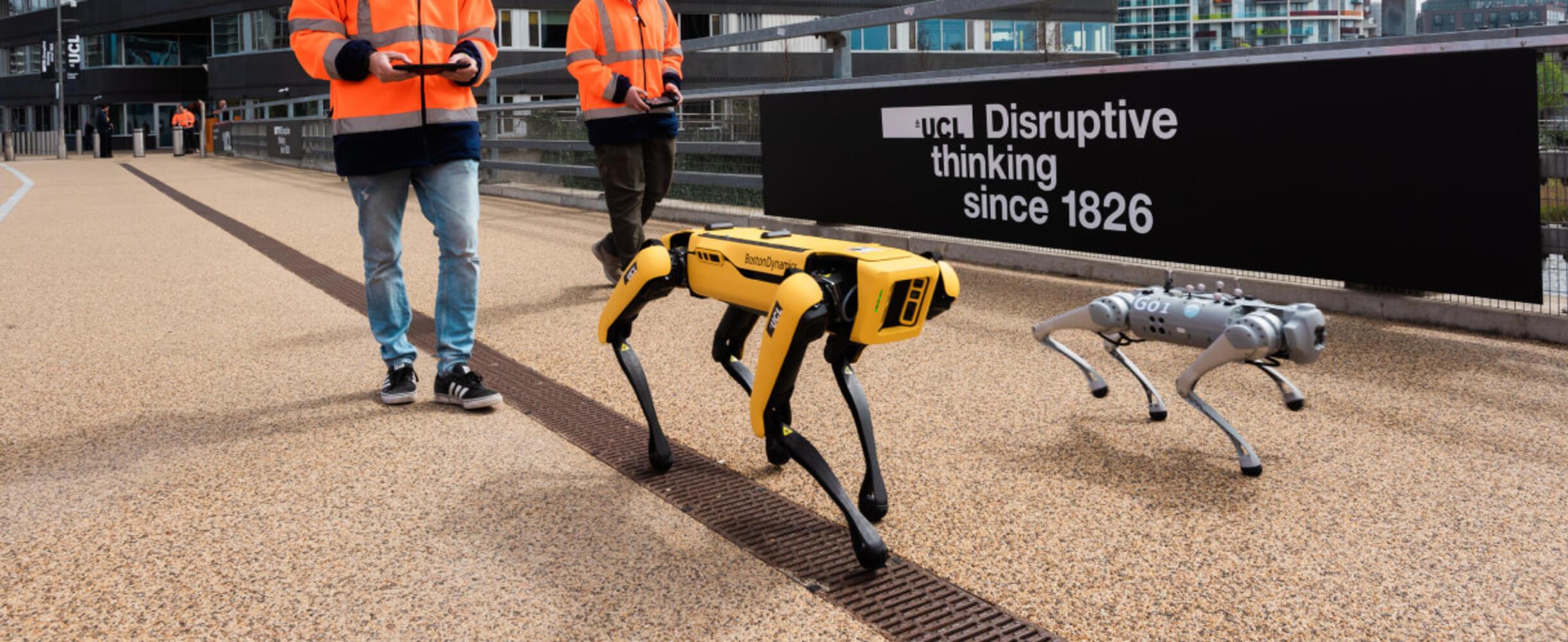 Two robots are walked in Queen Elizabeth Olympic Park near the new UCL East campus