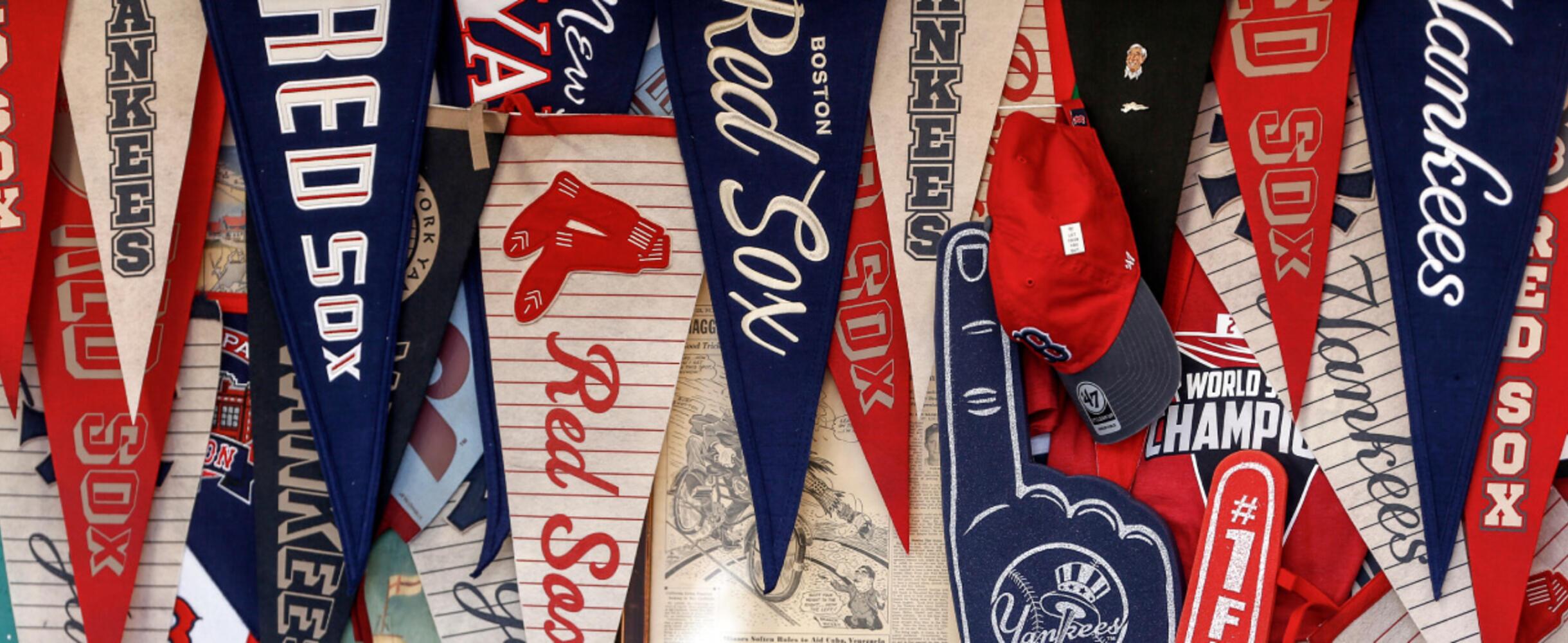 Flags from large MLB teams, displayed on a wall