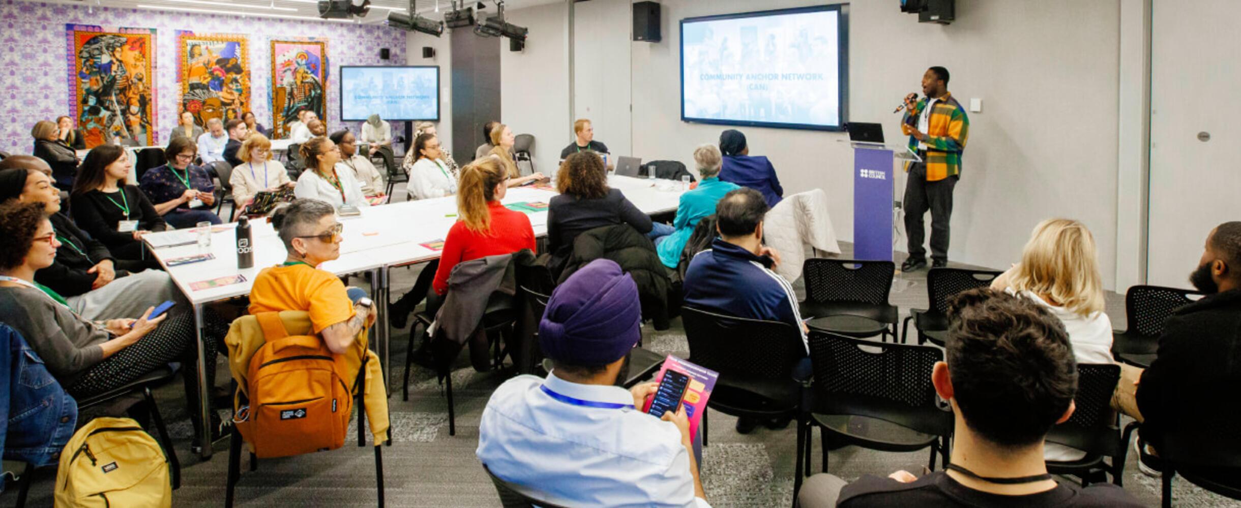 Community Anchor Network discussion with speaker and group listening