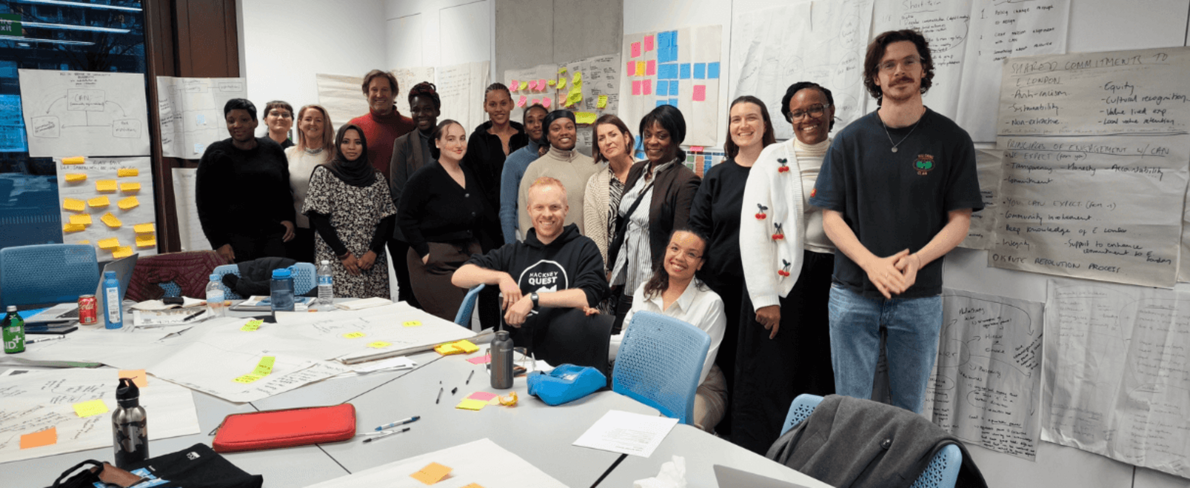A diverse group of people smiling in an office room