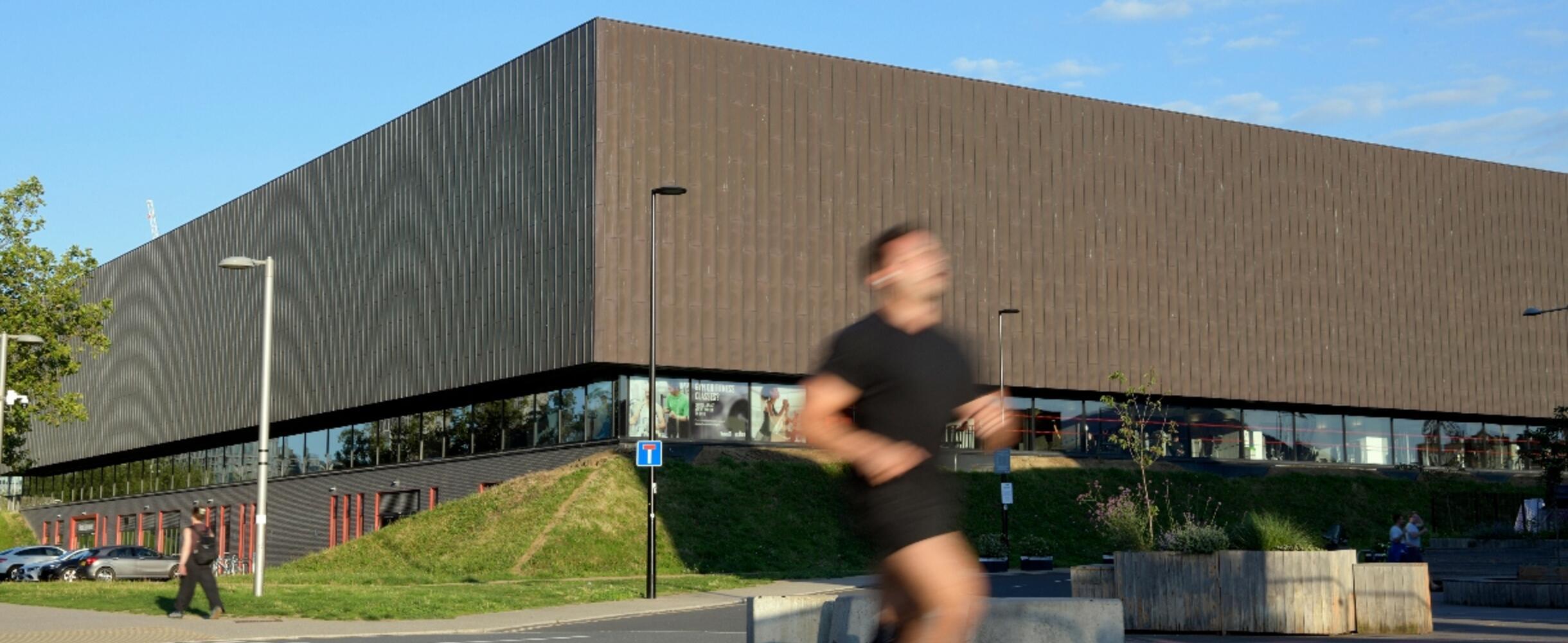A man running past the Copper Box Arena