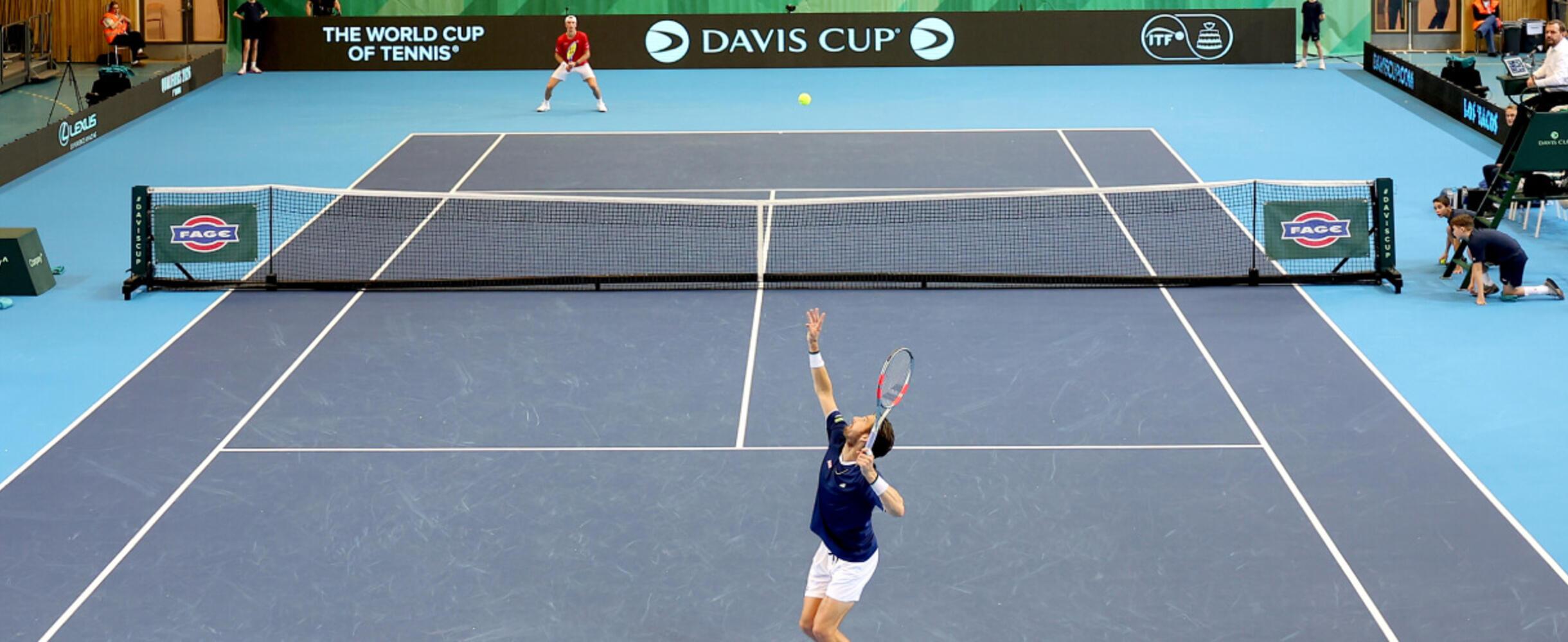 a player serves at David Cup match