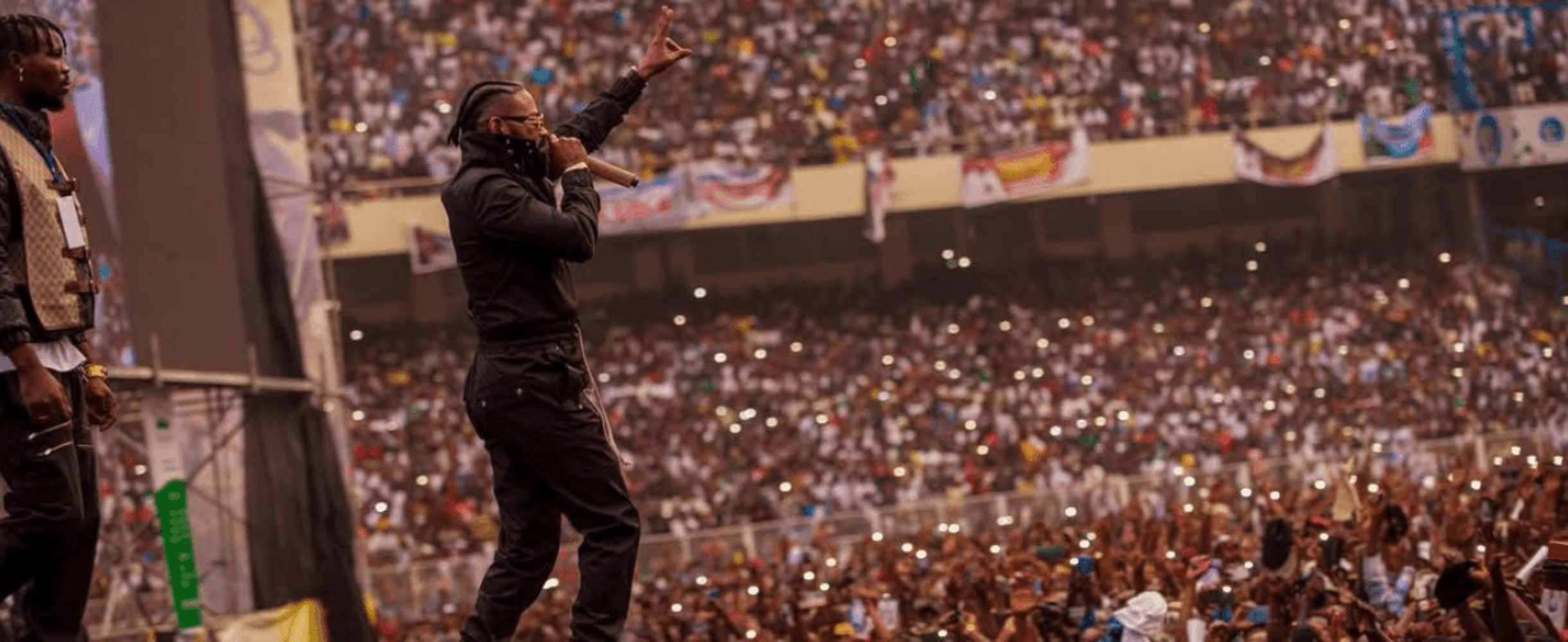 Ferre Gola performing on stage in front of a large crowd