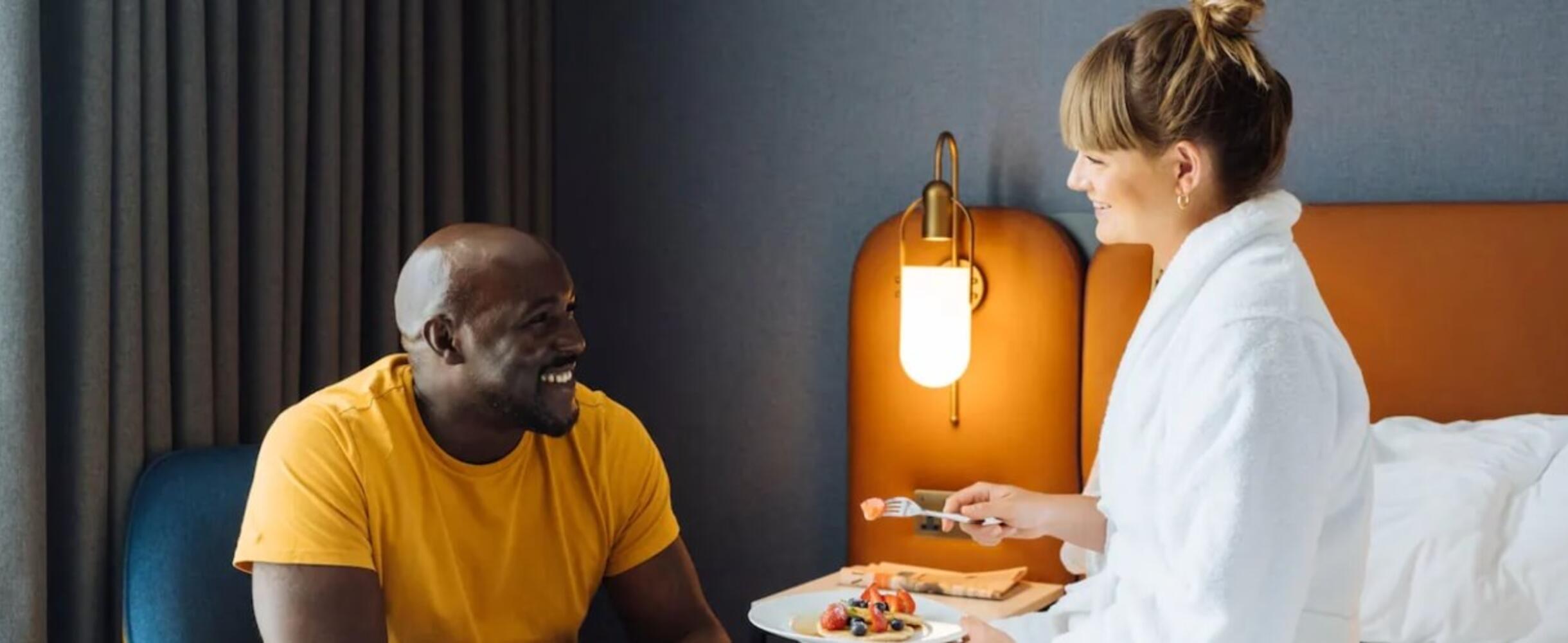 A couple chatting in a hotel room