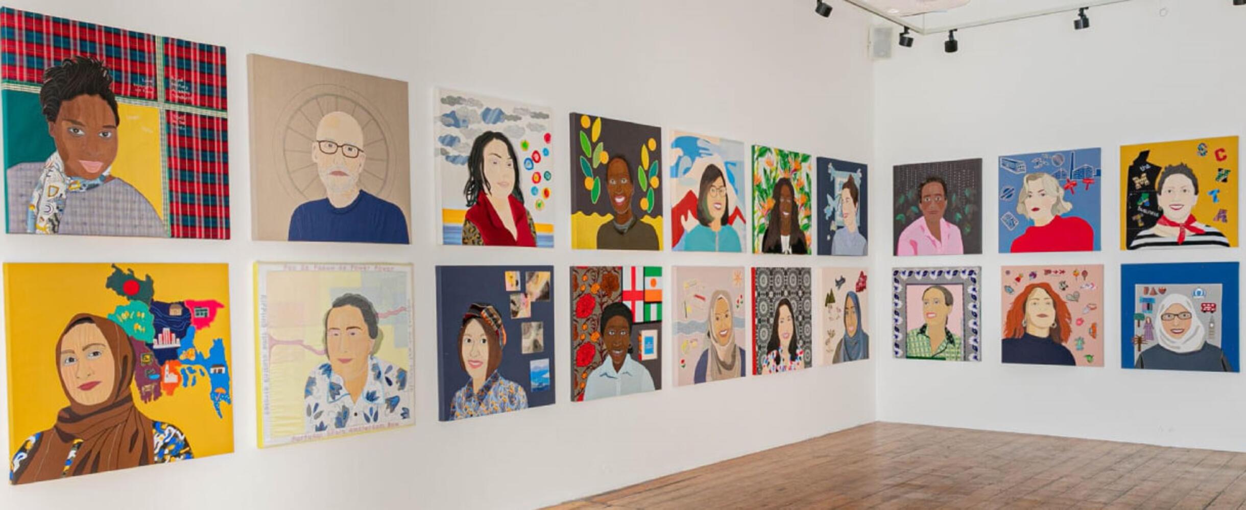 A display of artworks of faces on a wall