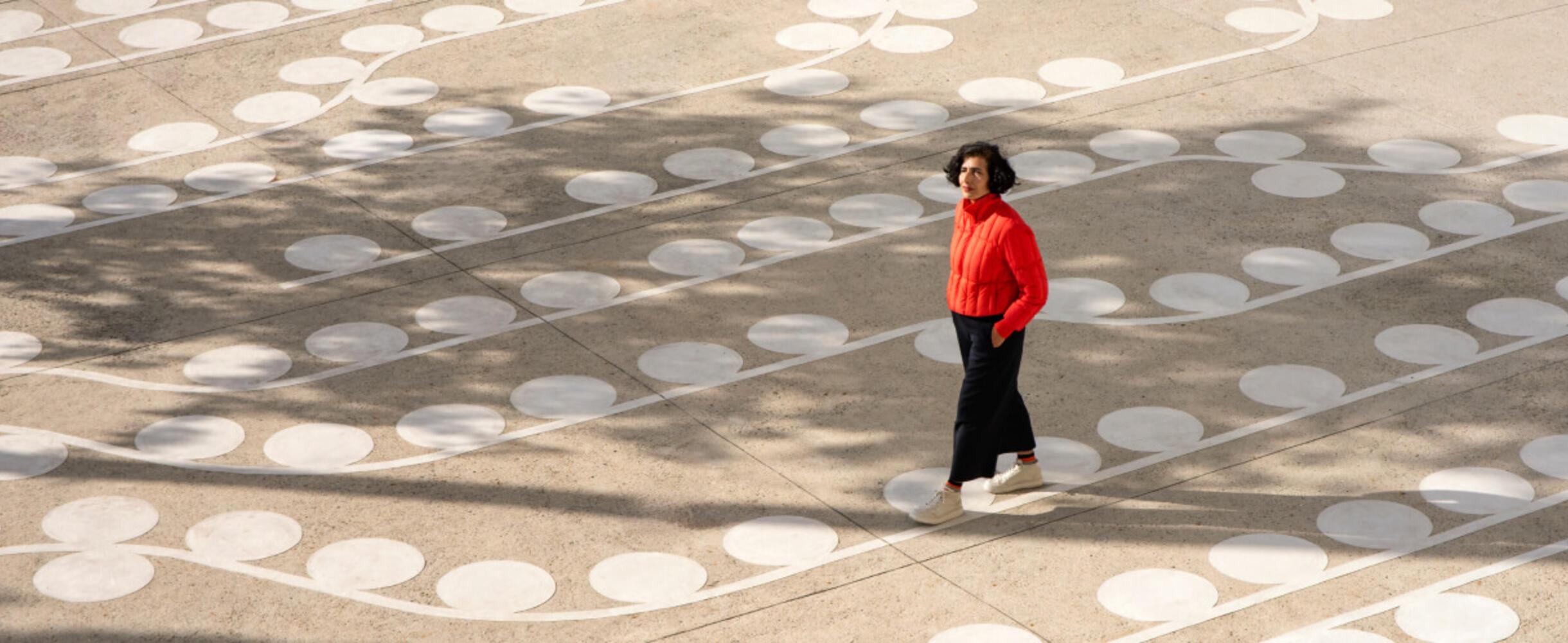 artist lubna Chowdhary walks across their artwork temporal trace