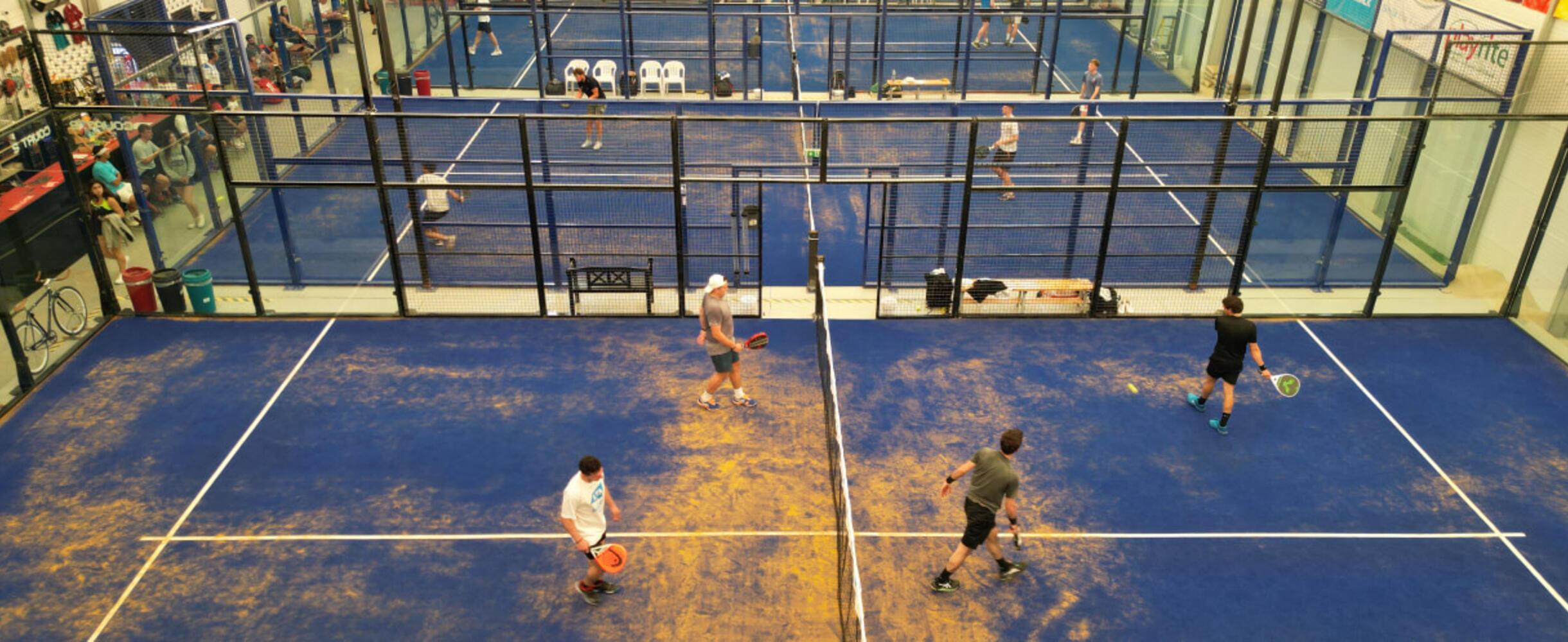 A series of Padel courts at Padel Stratford with players on them