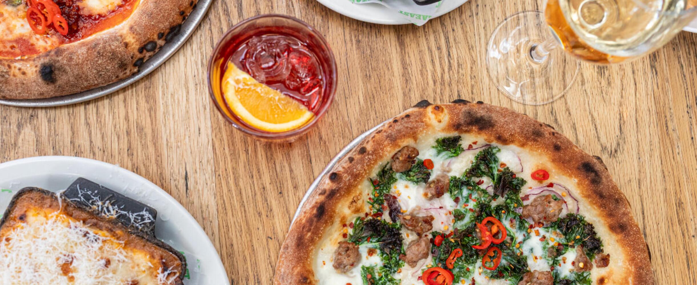 A photo of pizza and drinks at Pizza East