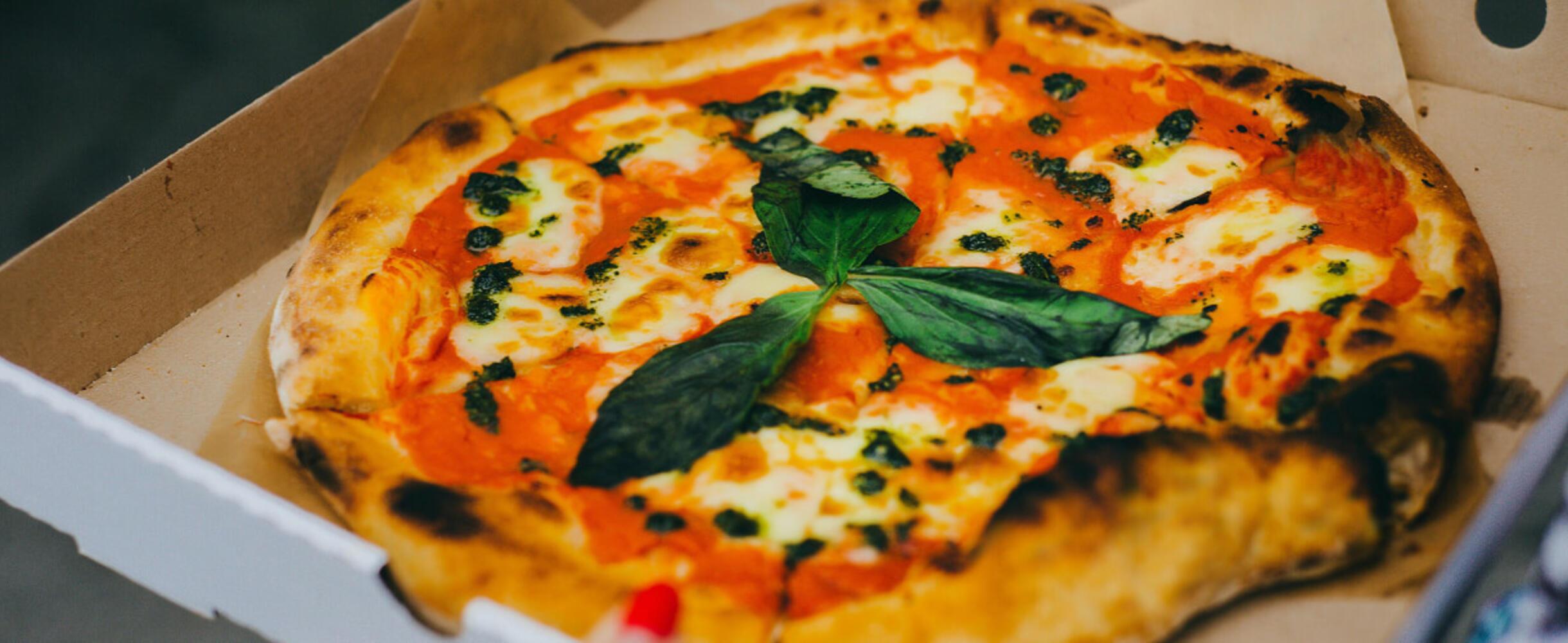 A pizza in a takeaway box