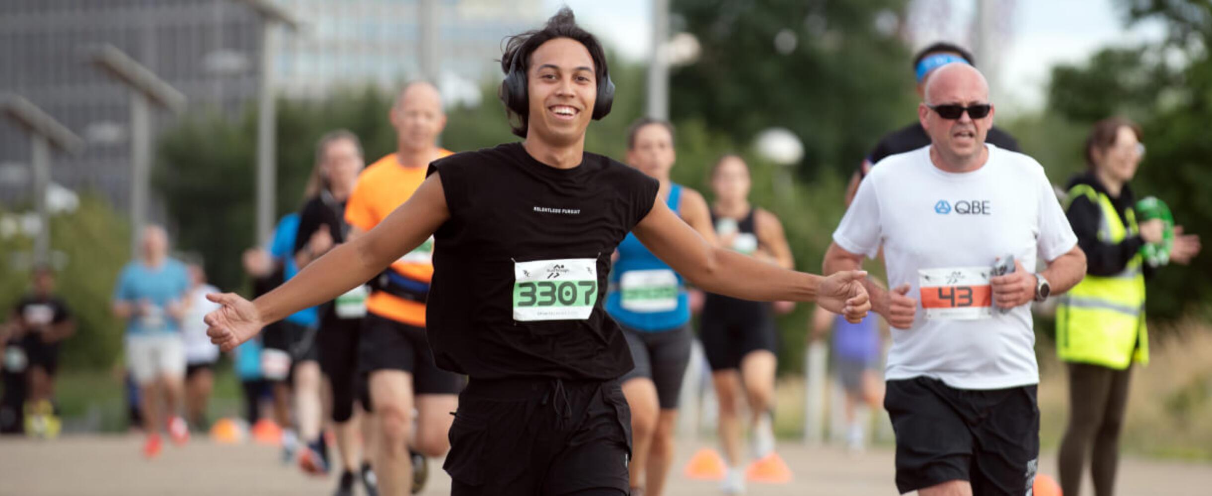 a runner with their arms out as part of a runthrough event