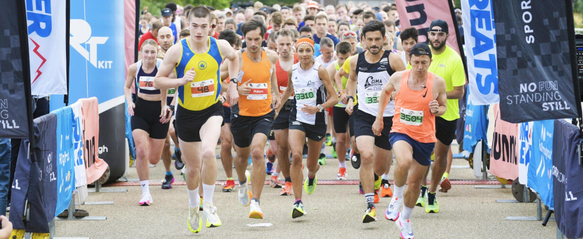A group of runners set off from the start line of a race