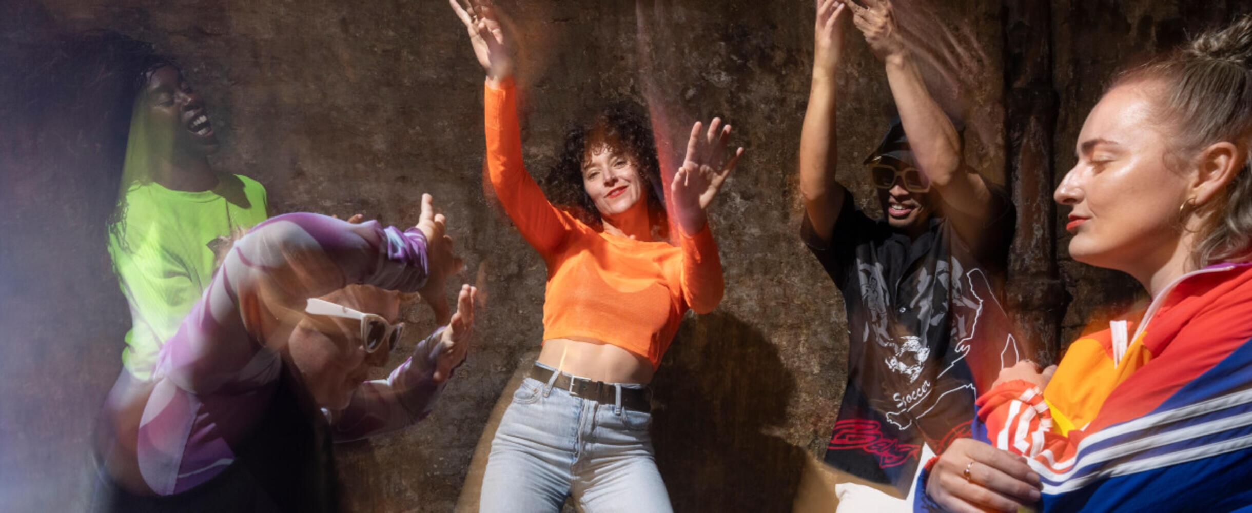 Dancer's in bright clothes performing in a blurry photo