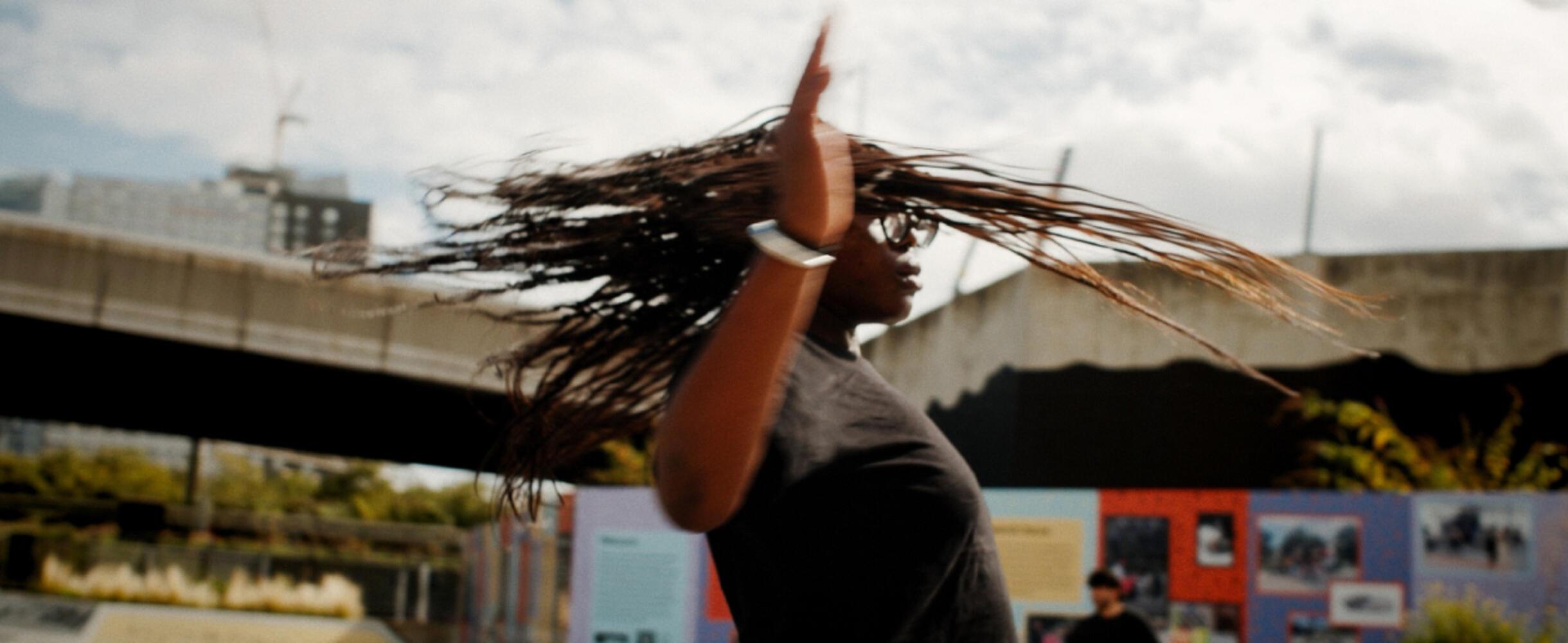 A person in motion, skateboarding