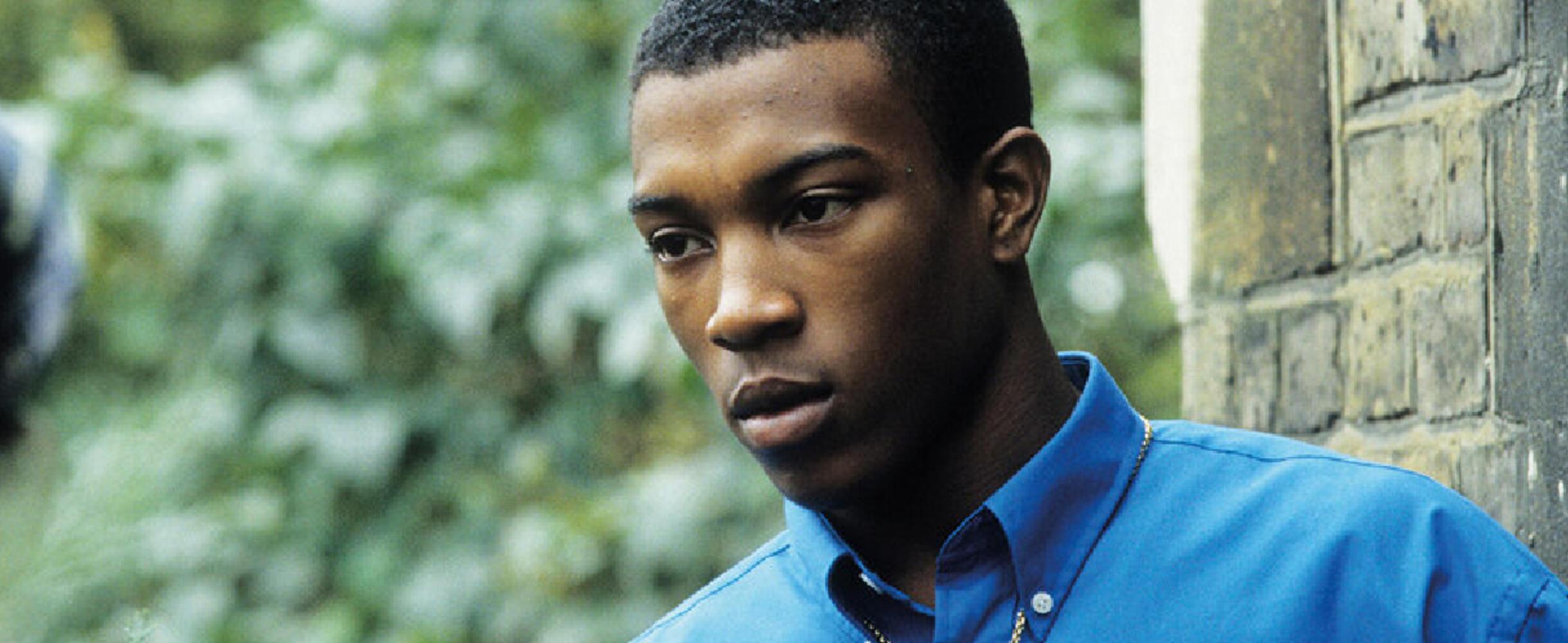 A young man stares off screen