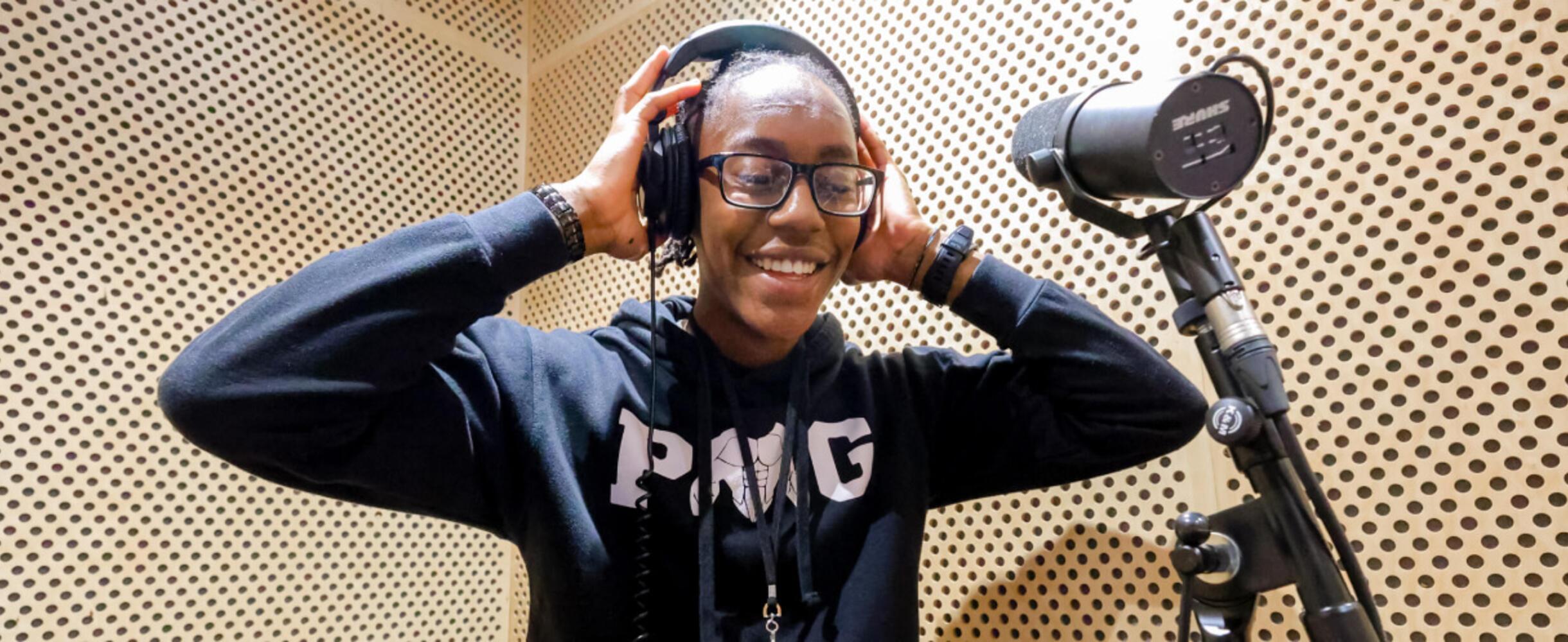 A young person in a recording booth