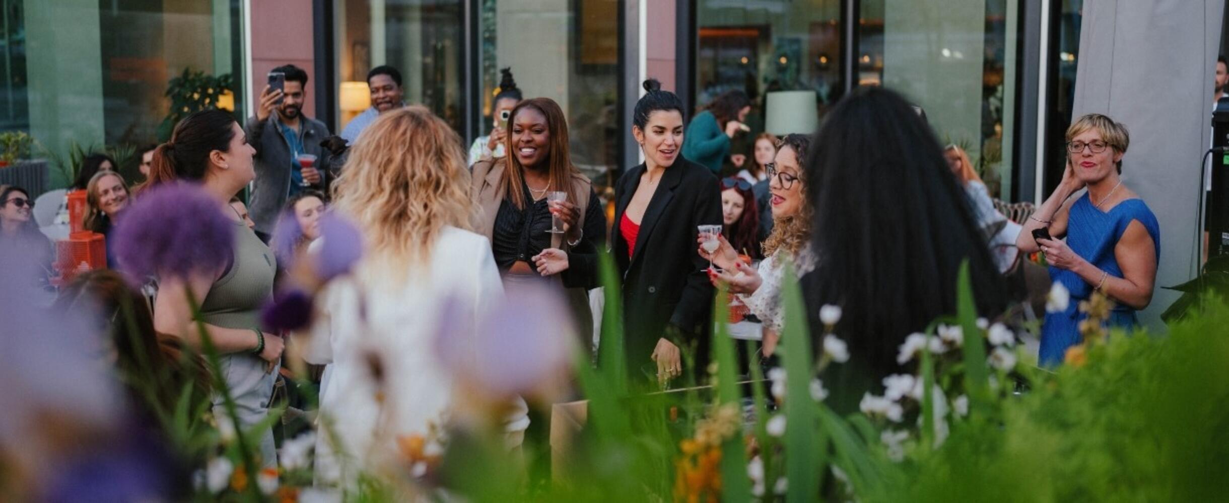 People dancing on a terrace outside Kitchen E20 restaurant