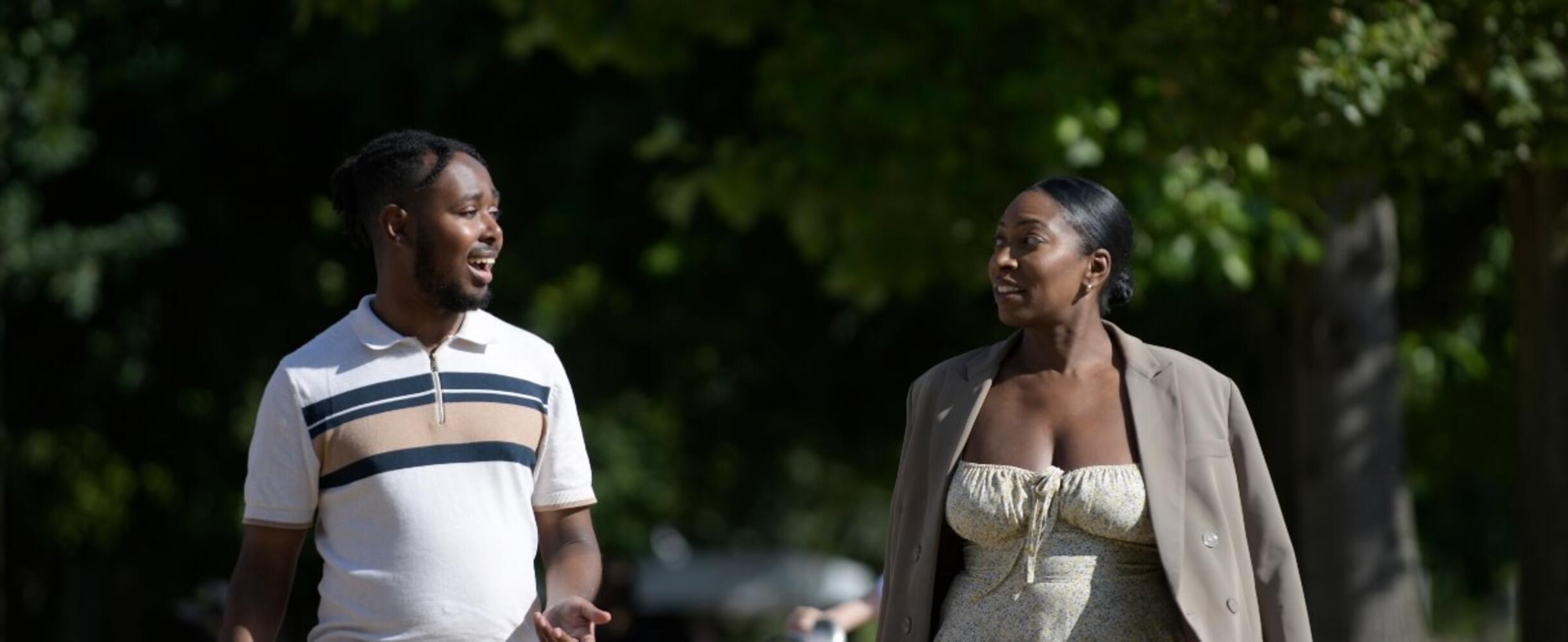 Two people walking and talking outside