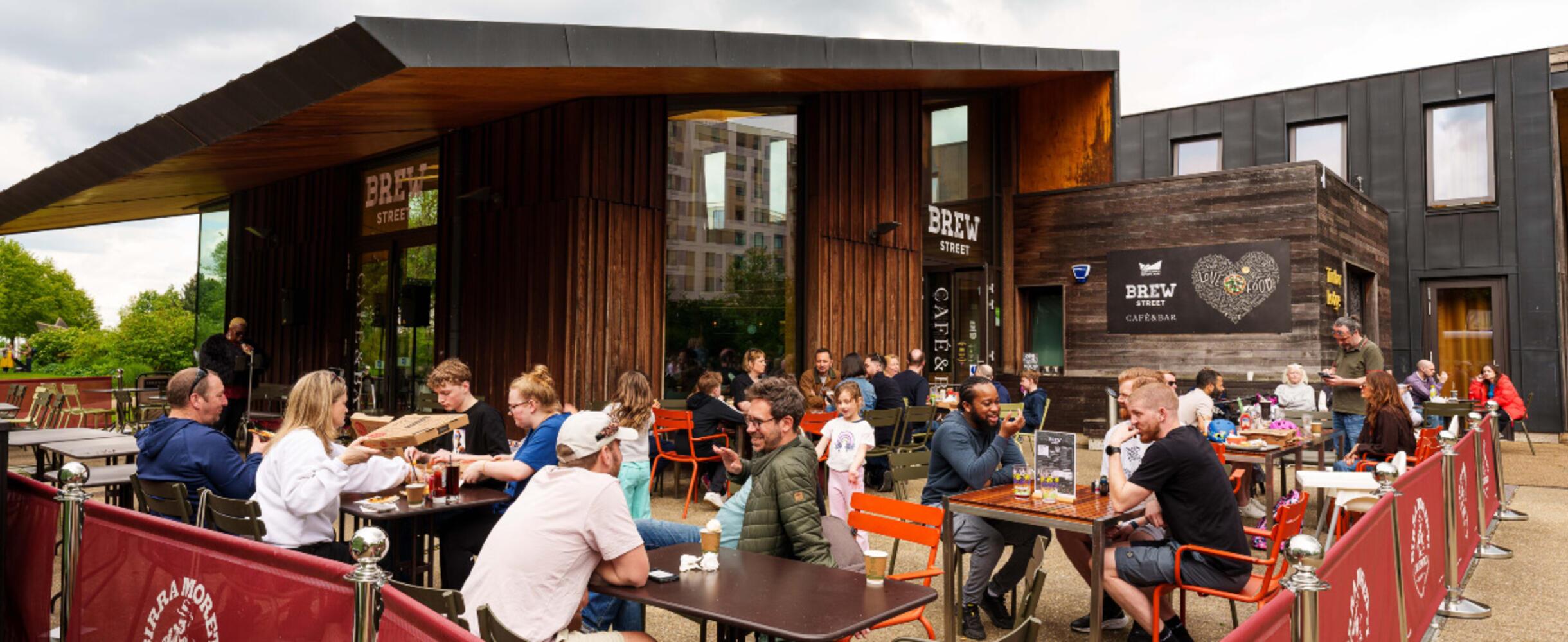 People enjoying the outdoor terrace at Timber Lodge