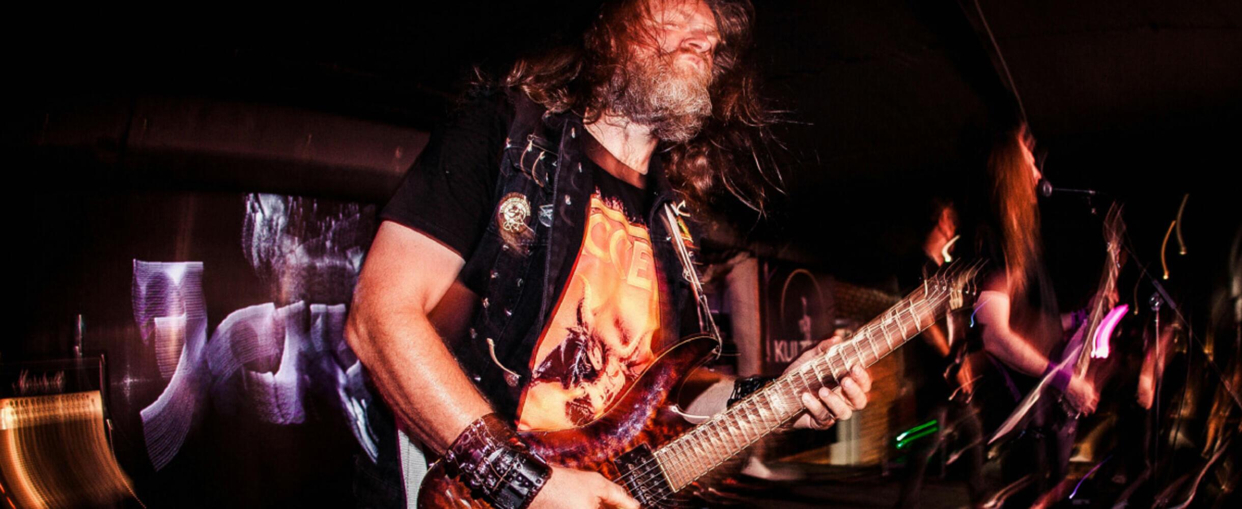 A man plays a guitar on stage