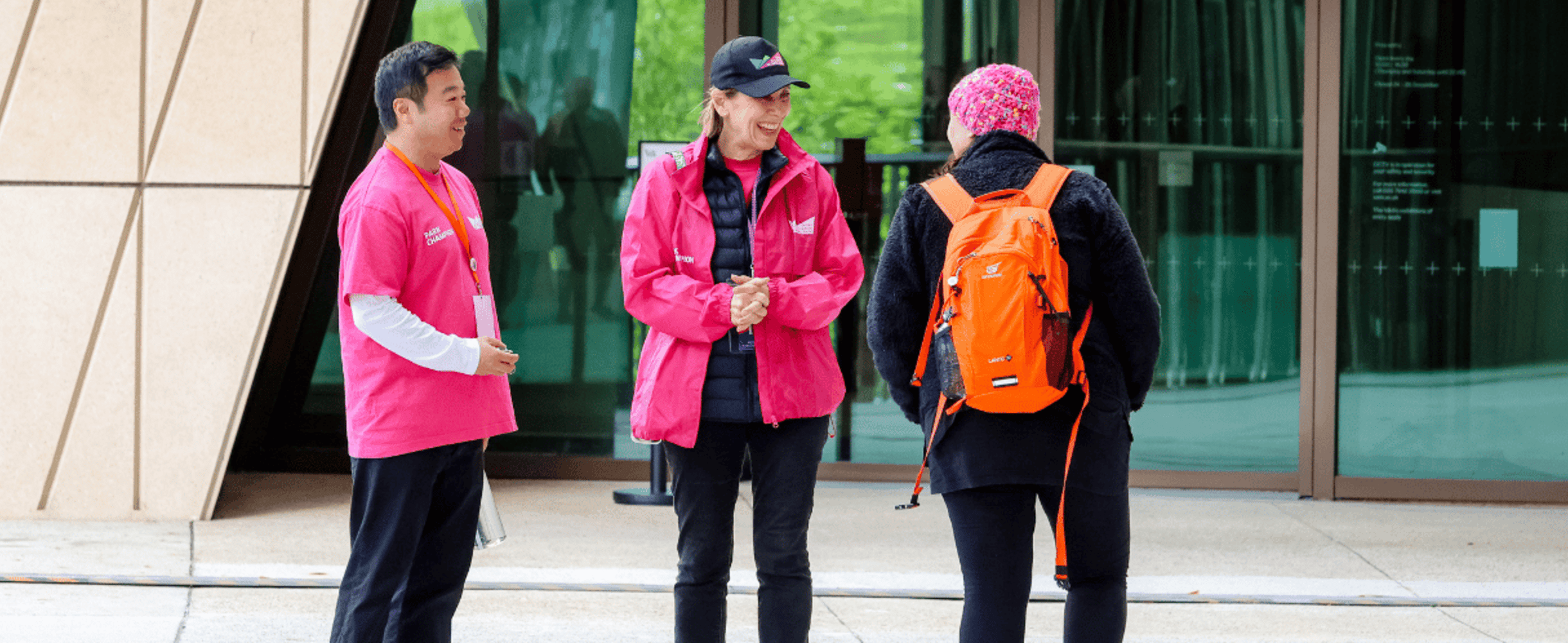 Volunteers talking to a visitor on Queen Elizabeth Olympic Park