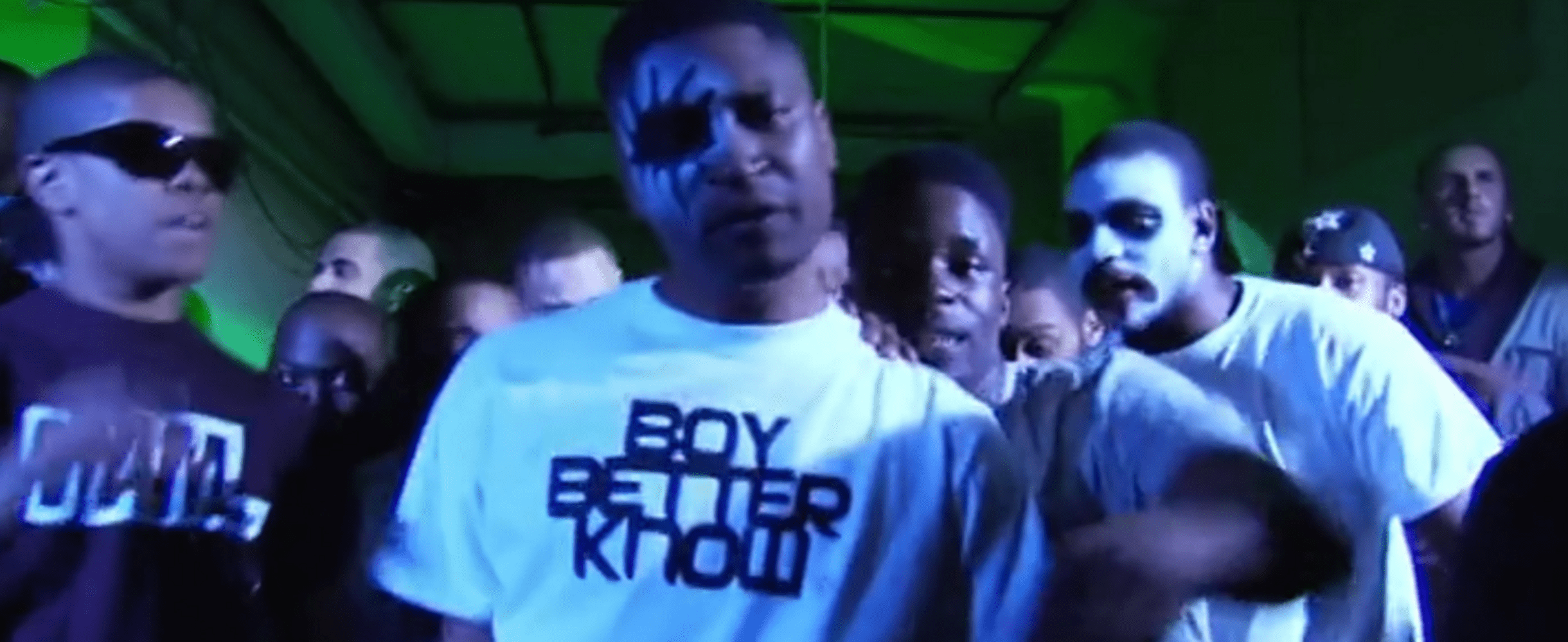 A group of men in face paint in a music video