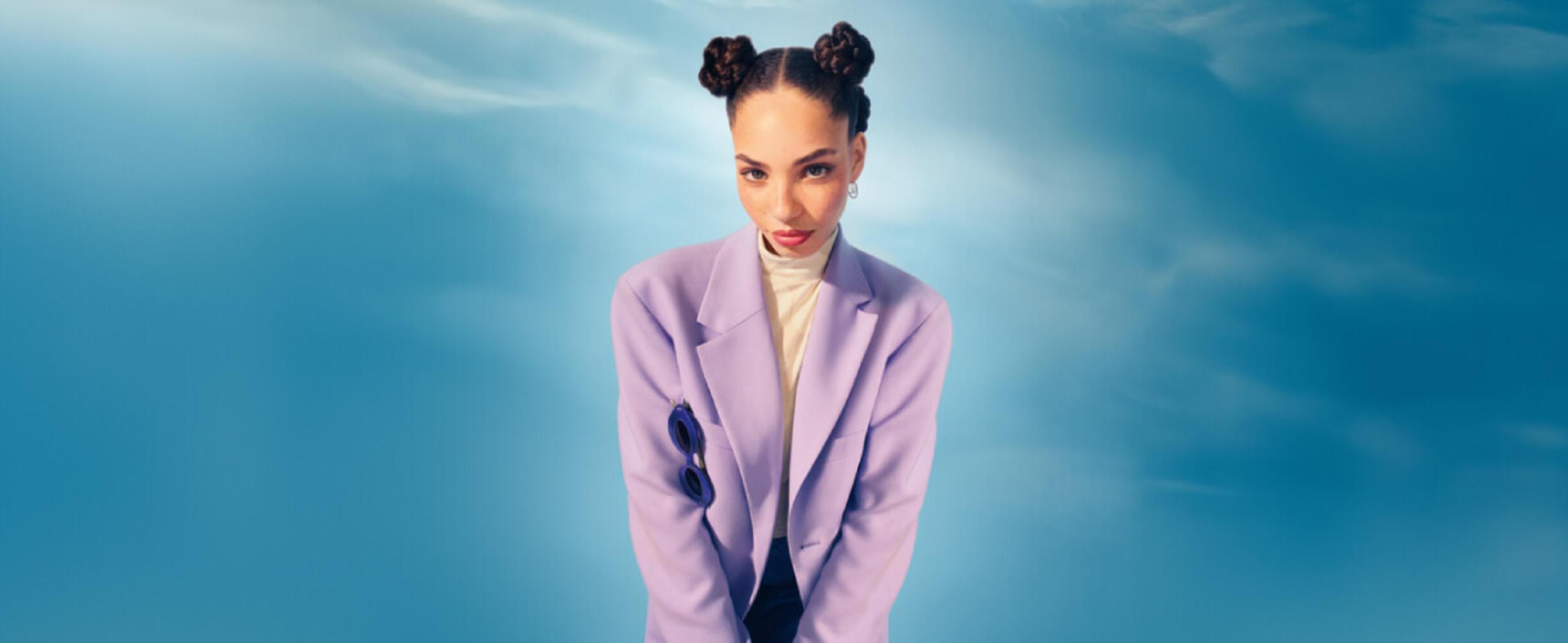 A person stands in the middle of a blue background