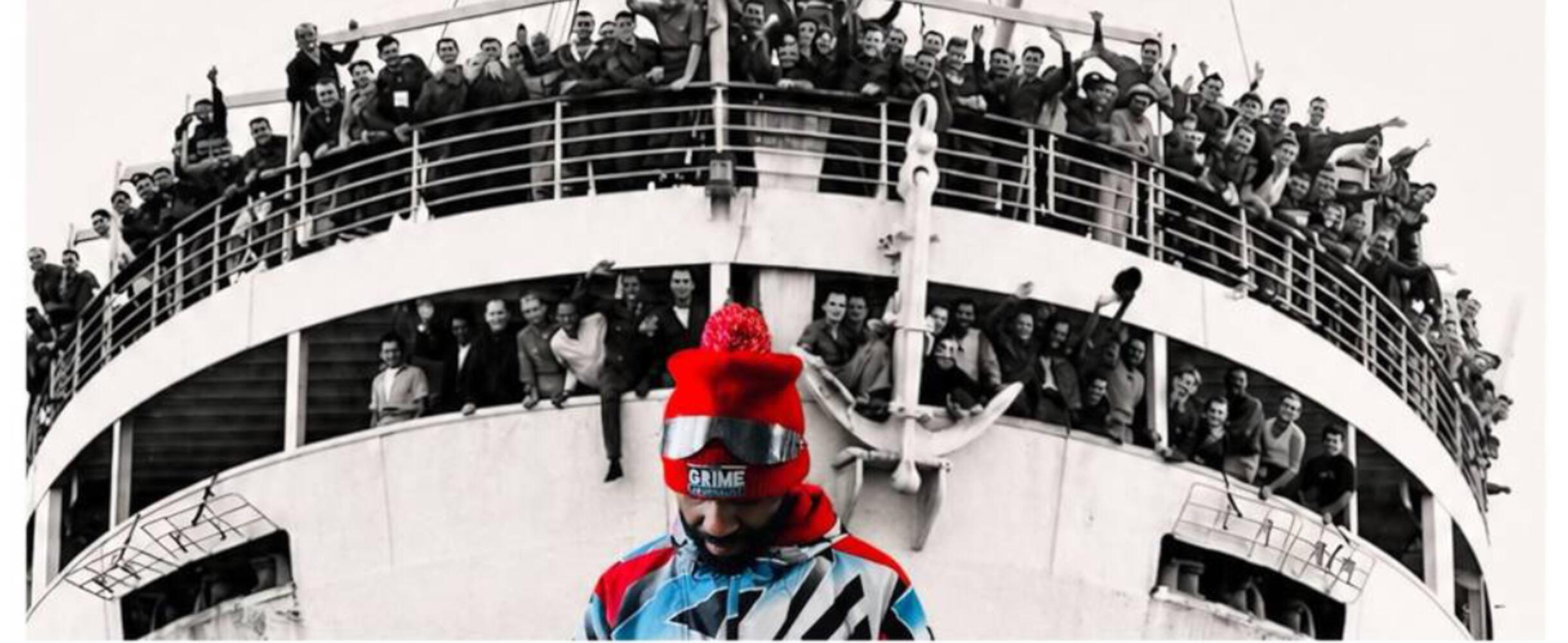 A person stands in front of a boat of people