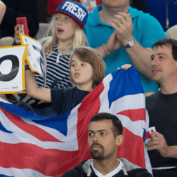 Photo of a crowd holding up a union jack flag and a number 10