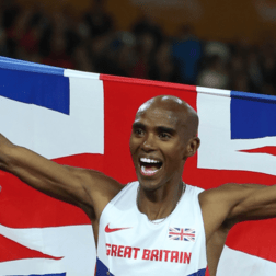 Mo Farah holding up a union Jack flag at London Stadium