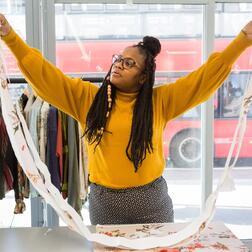 A person holds up a length of fabric