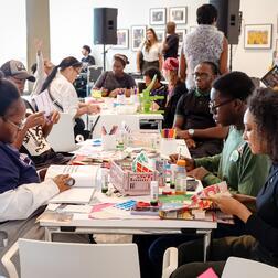 Sounds & Stories at V&A East with a table of people at a workshop