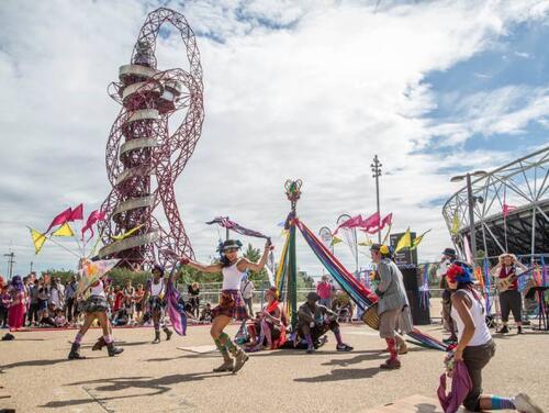 People in fancy dress with London Stadium in the background