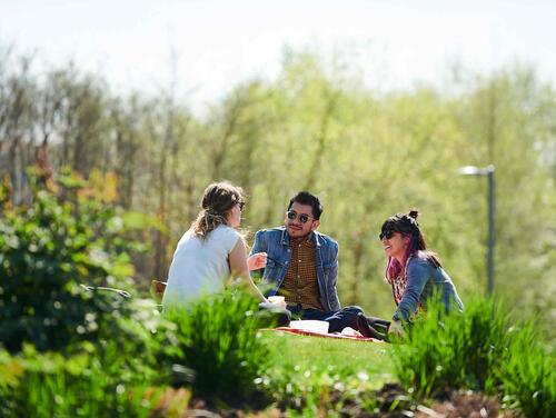 Friends sitting in the Queen Elizabeth Olympic Park