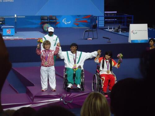 Three paralypmic athletes celebrating during a medal ceremony