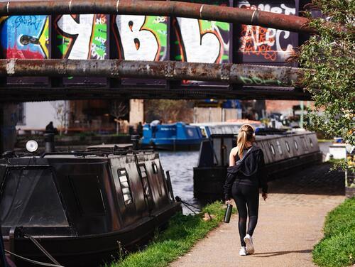 Woman walking on canalside path