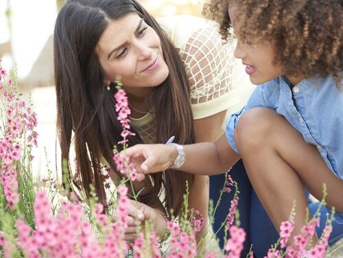 Mum and daughter looking at flowers